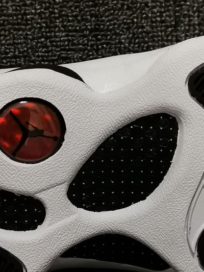 Close-up of the white outsole with black sections and a red circular heel detail