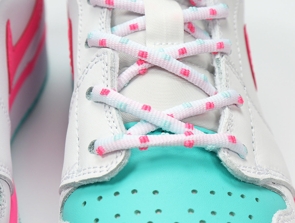Close-up of the aqua perforated toe panel, white overlays, and pink-and-aqua patterned laces.
