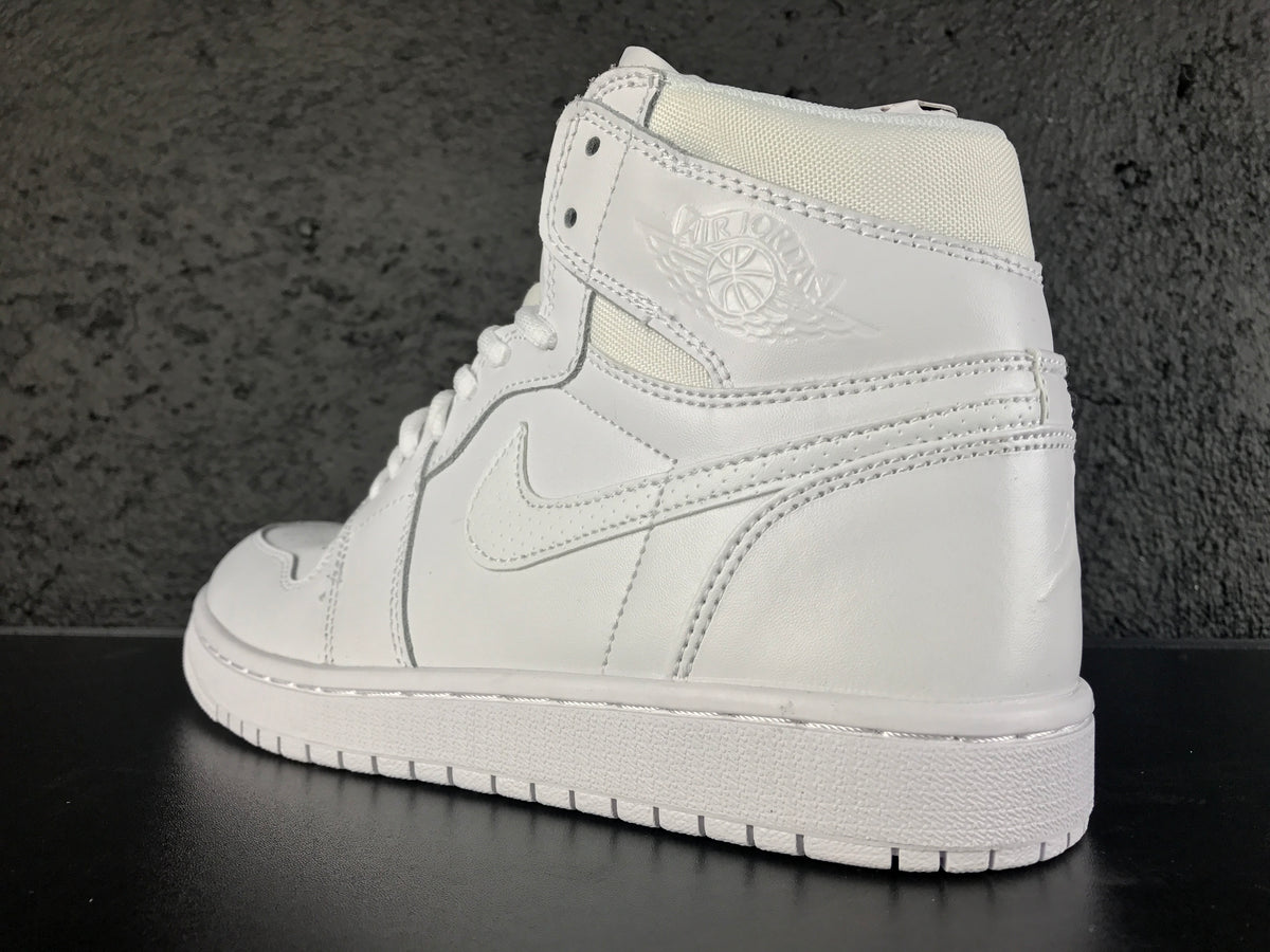 Rear-side view showing the Jordan Wings emblem, heel panel, collar construction and white outsole.