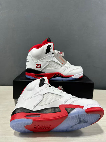 Two white, red, and black high-top sneakers shown from side and outsole angles, highlighting the translucent rubber outsole and red midsole.