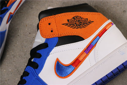 Close-up of the white side panel, blue and orange Swoosh detail, black collar and orange Jordan branding panel.