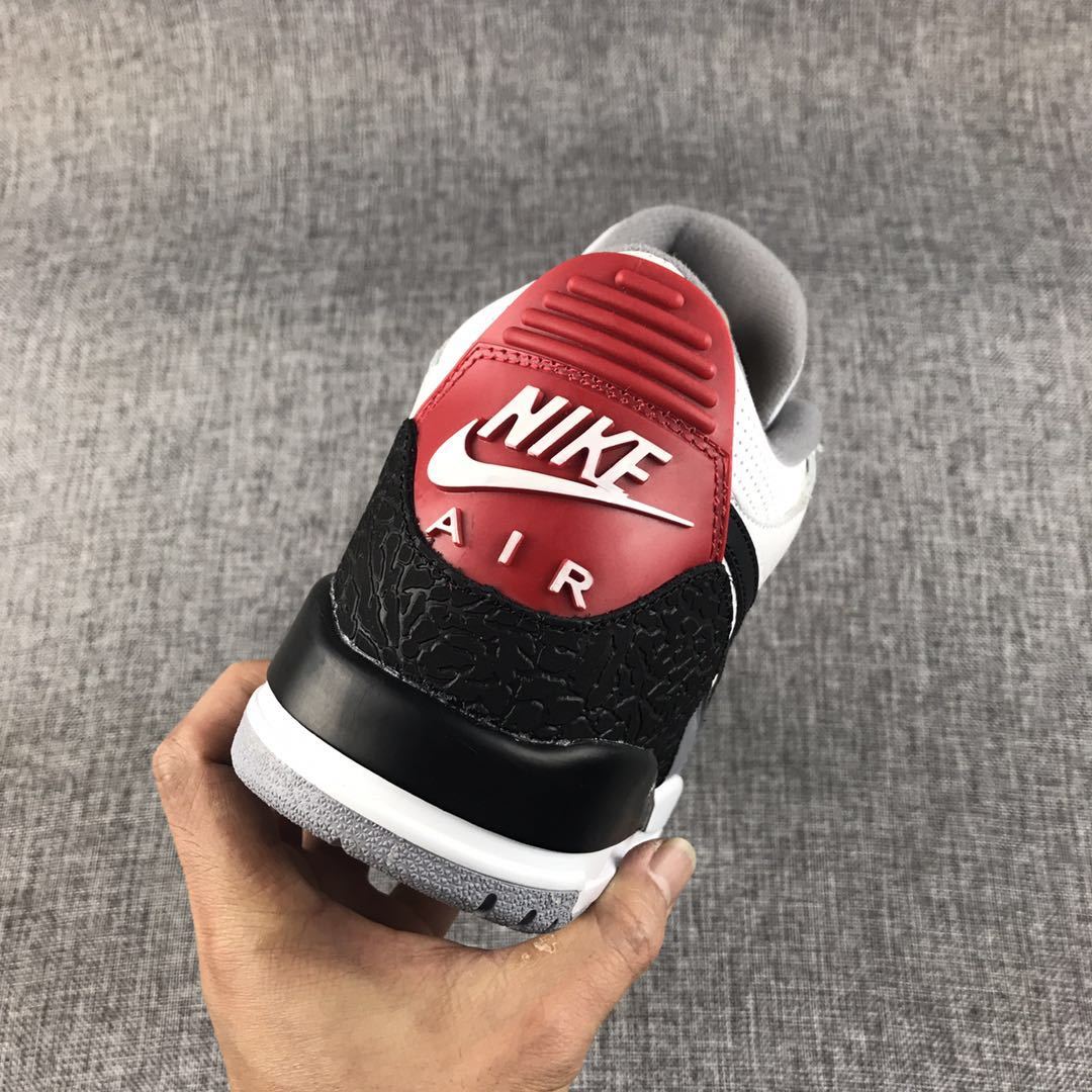 Rear view showing the red heel panel, white branding, black heel overlay, and grey outsole.