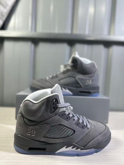 Side view of a grey high-top sneaker showing the ventilated side panel, number 23 detail, layered upper, and translucent outsole.