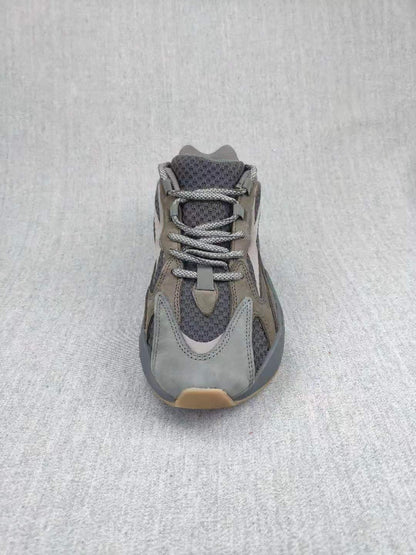 Top-down view of the gray sneaker showing the laces, tongue, toe box, and layered upper.