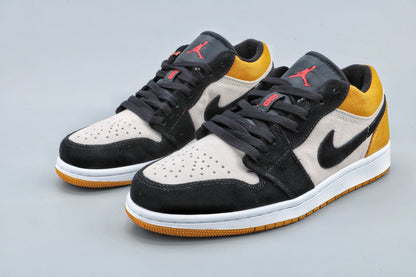 Front three-quarter view showing the black toe overlays, light toe boxes, yellow collars, and Jordan tongue logos.