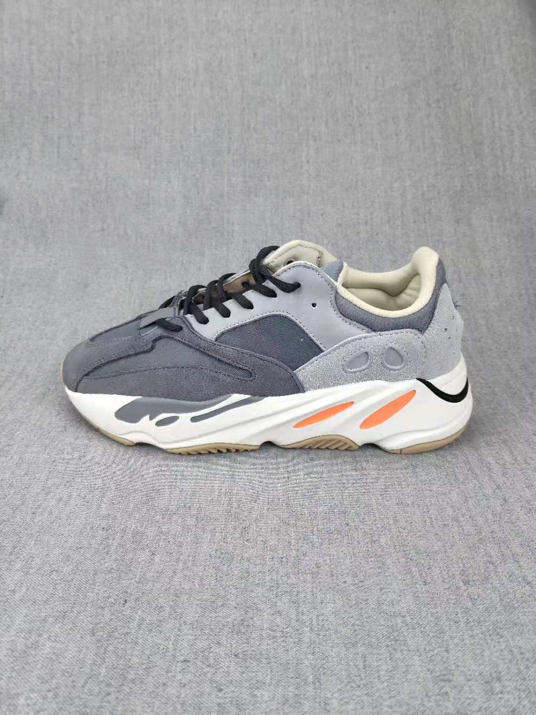 Side profile highlighting the sculpted white midsole and orange accent details.