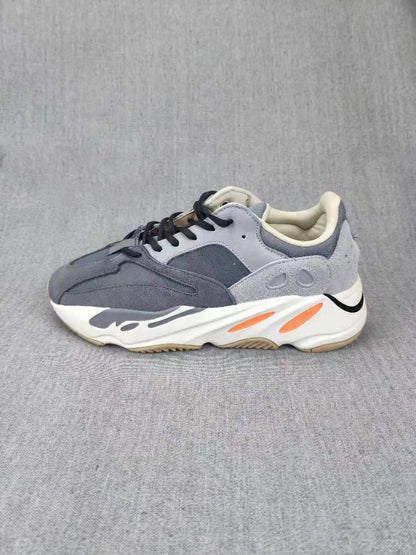 Side profile highlighting the sculpted white midsole and orange accent details.