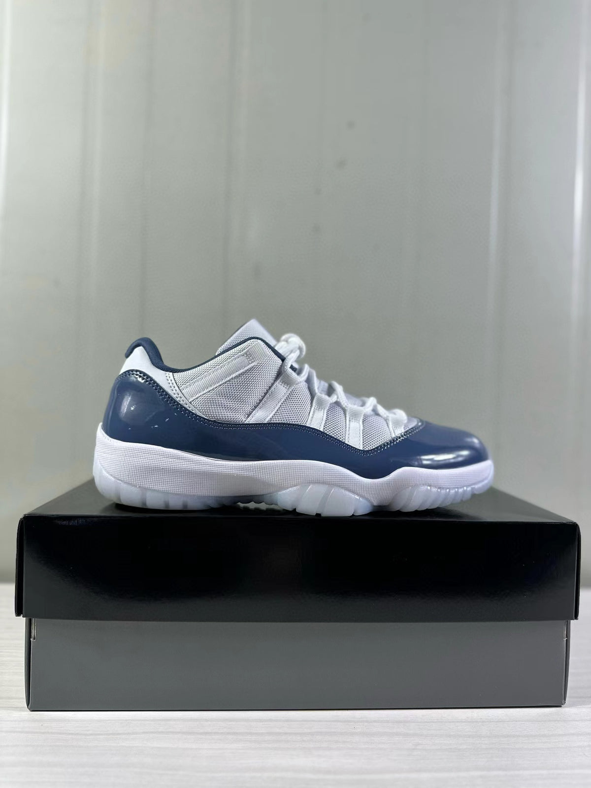 Side profile of the Jordan Air Jordan 11 Low on a display box