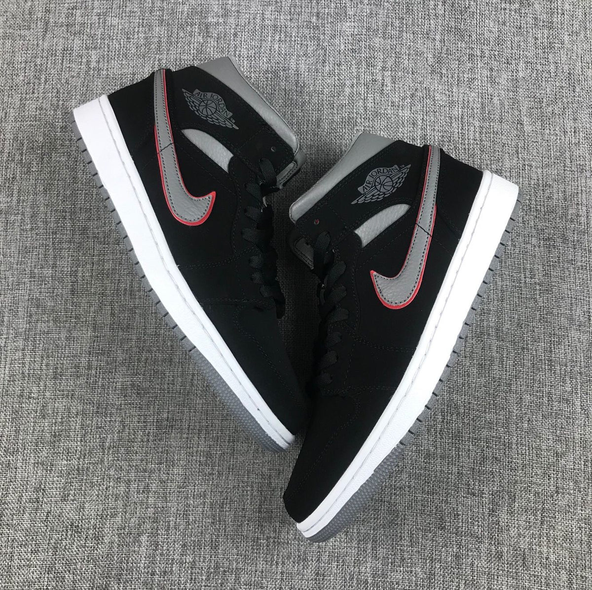 Top-down view of the pair showing black laces, grey collars and contrasting Swoosh details.