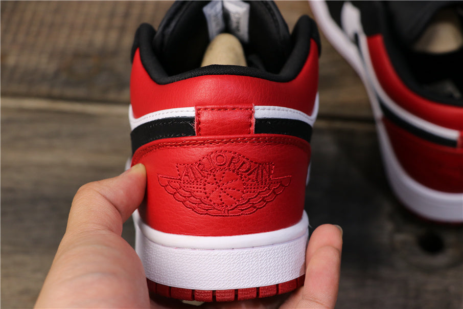 Rear view showing the red heel panel, white stripe, black trim, and embossed Jordan Wings design.