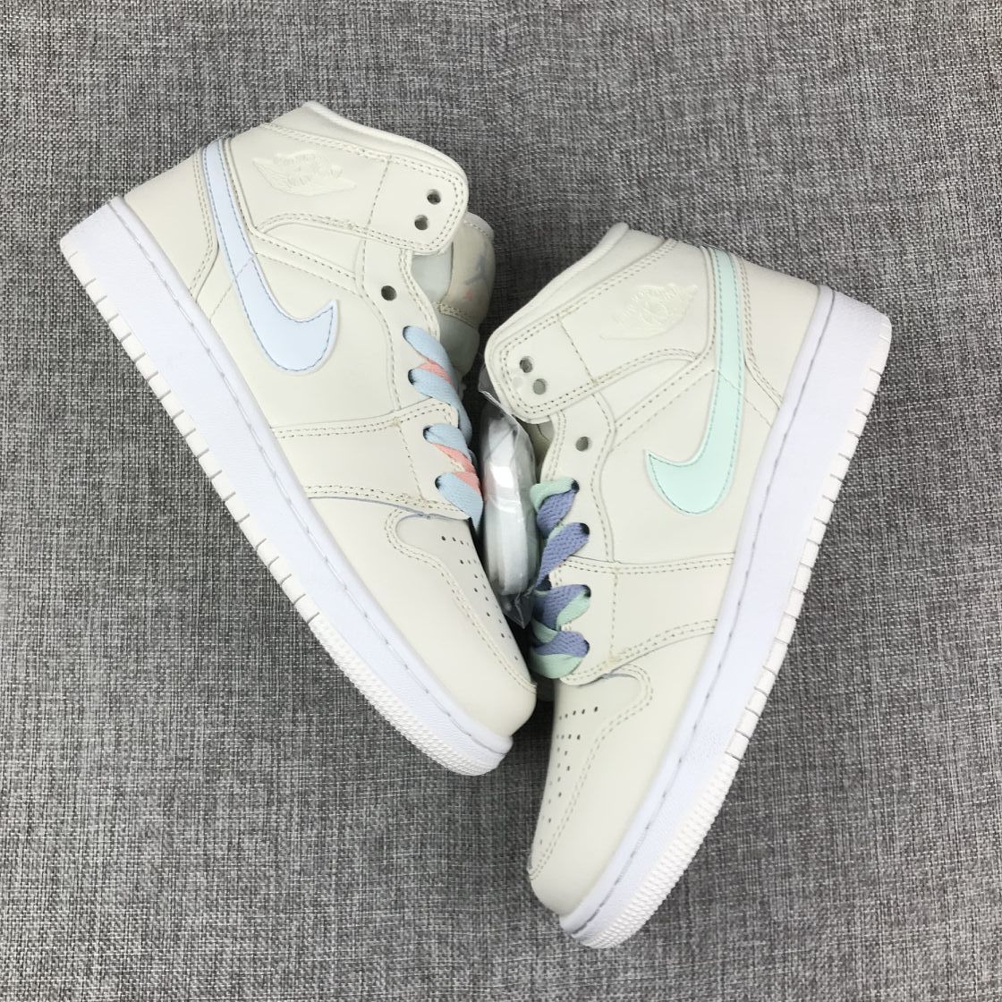 Top-down view of the pair displaying mismatched pastel Swoosh colors and multicolor laces.