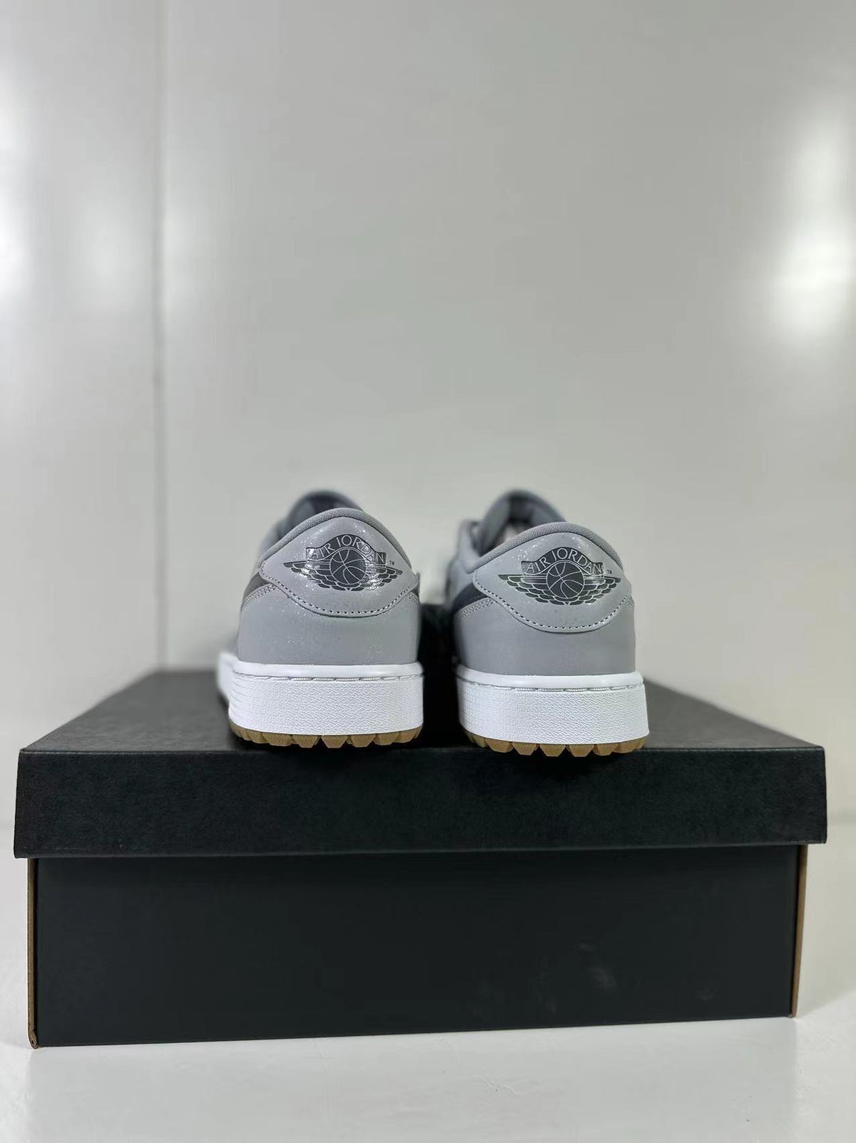 Rear view showing the Jordan Wings branding on the heels and gum-colored outsole edges.