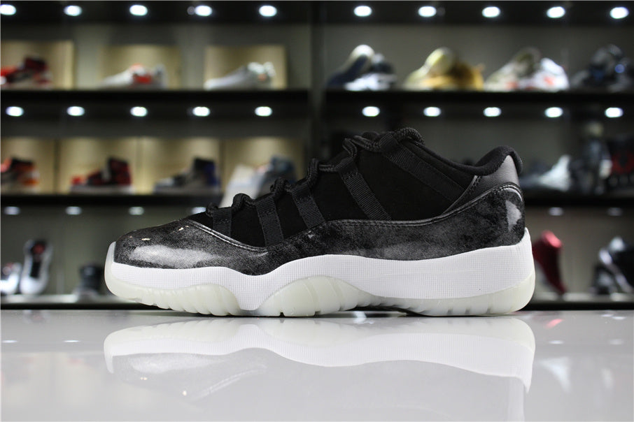 Side profile of the sneaker showing the silver-black upper, white midsole, and translucent outsole.