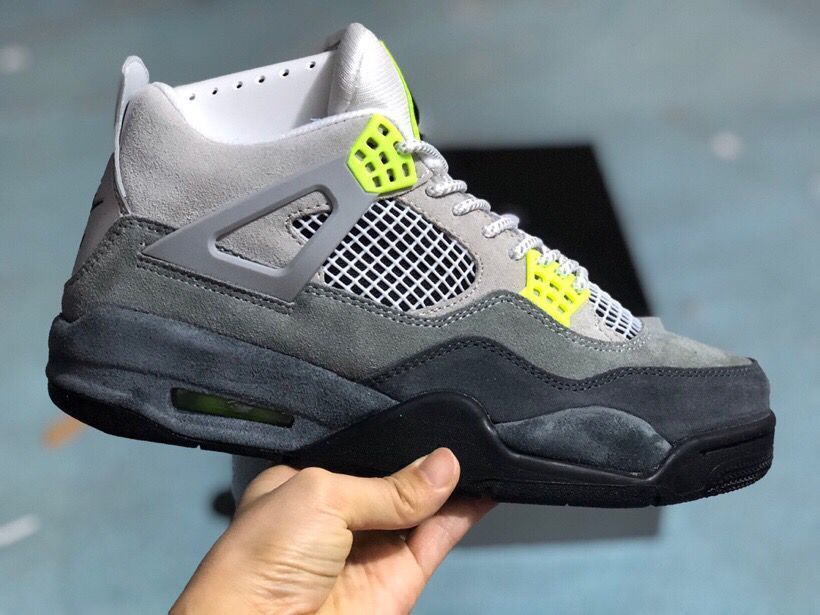 Side profile of the grey, black, and bright green high-top sneaker with a visible heel air window.