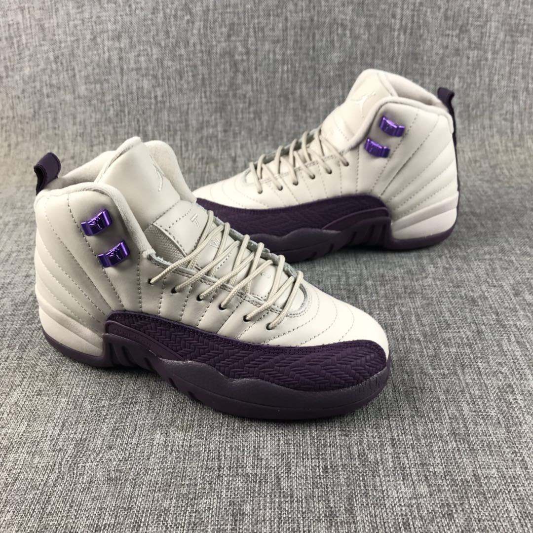 Air Jordan 12 sneakers shown from the side with off-white panels and deep purple overlays