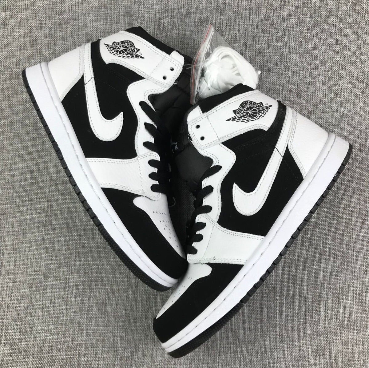 Overhead view of the black-and-white high-top sneaker pair