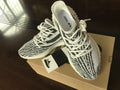 Top view of the black-and-white patterned sneakers with white laces and translucent soles.