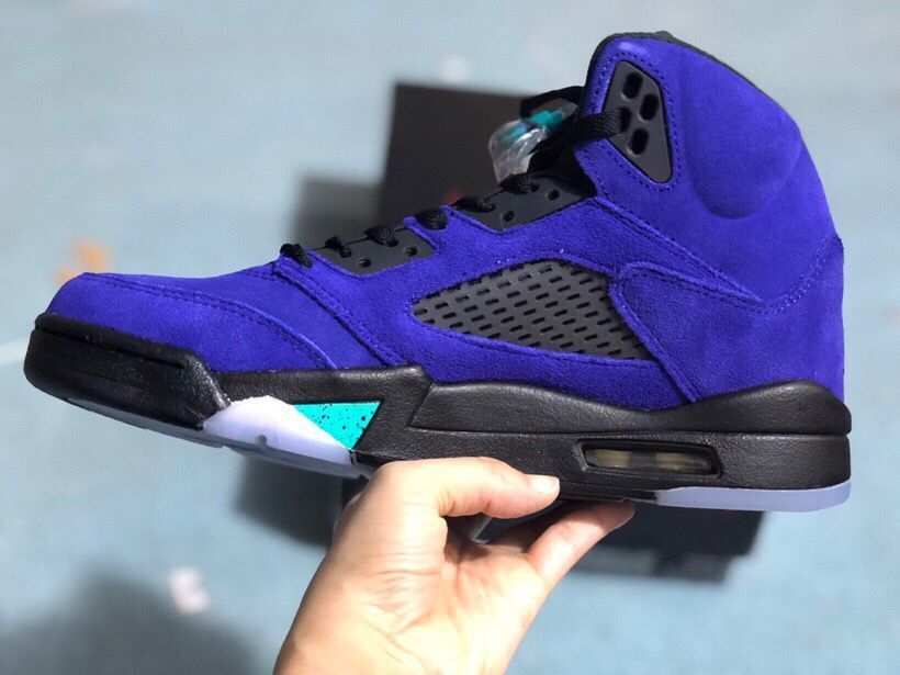Side profile highlighting the purple upper, black midsole, turquoise accent, mesh panel, and visible heel air unit.