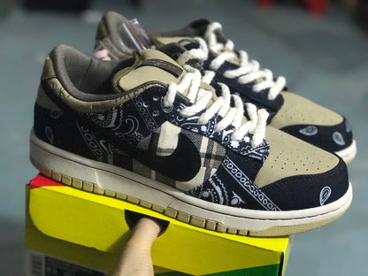 Three-quarter view of the sneakers showing the patterned upper, dark Swoosh, light laces, and beige toe and outsole details.