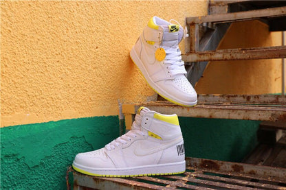 Side profile of the white and yellow high-top sneakers displayed on a metal staircase.