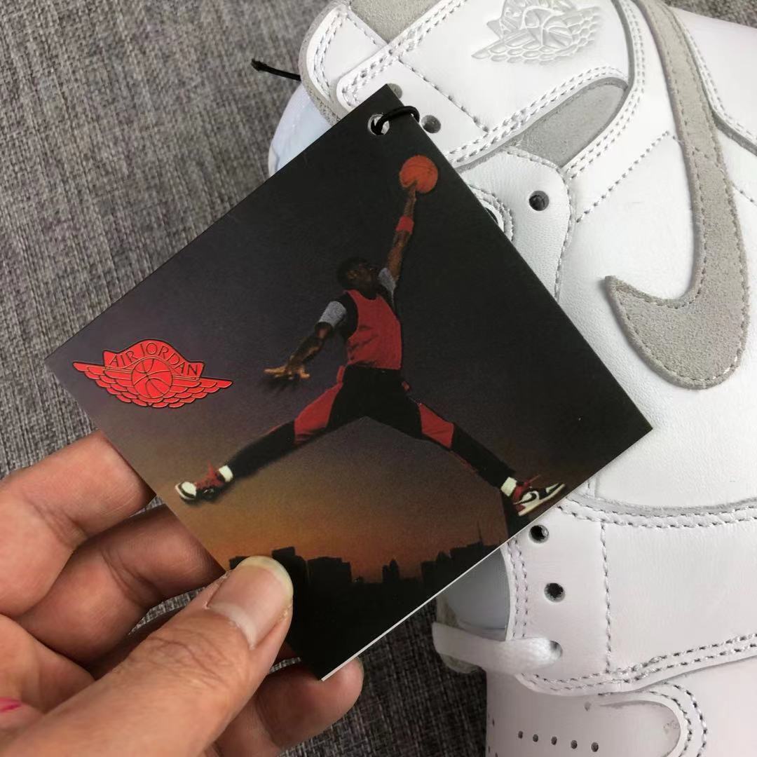 Close-up of the ankle wings emblem, grey Swoosh, and attached graphic tag.