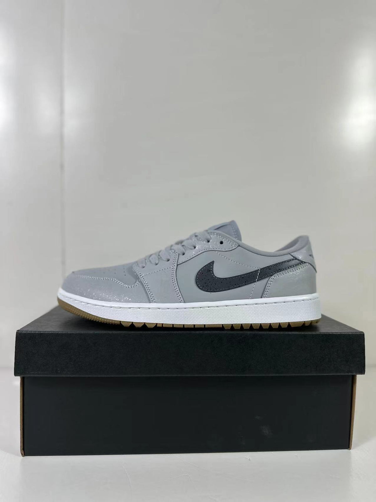 Side profile of a grey and blue low-top sneaker with dark Swoosh branding and a white midsole.