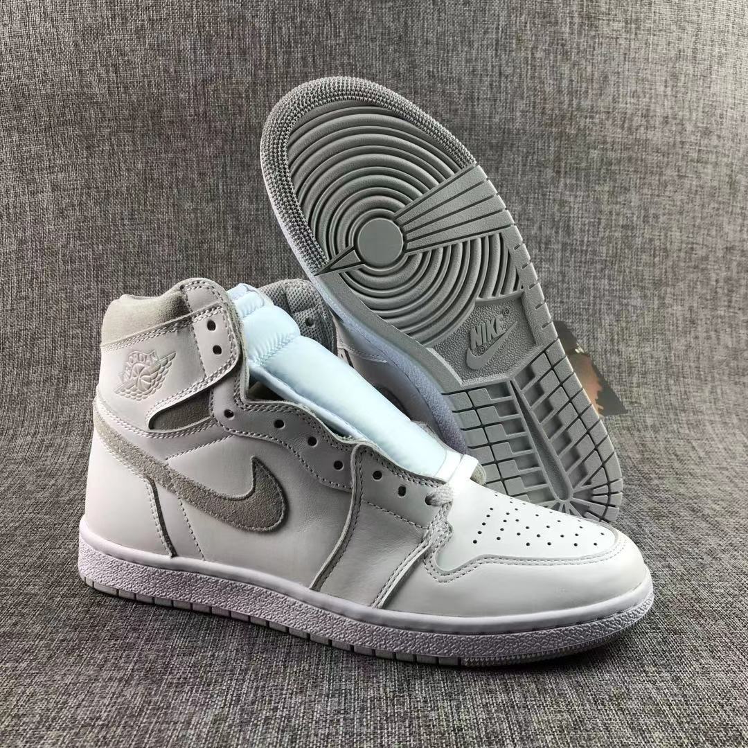 High-top sneaker beside its outsole, showing the tread pattern and grey accents.