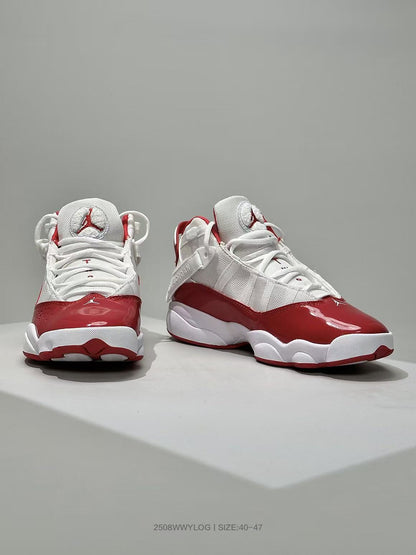 Front three-quarter view of the white and red high-top Jordan sneakers with glossy red toe panels.