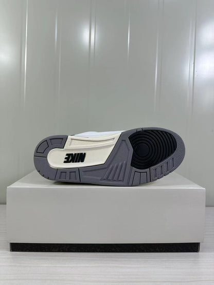Outsole view showing a gray rubber tread with black circular traction detail and a white inset panel.