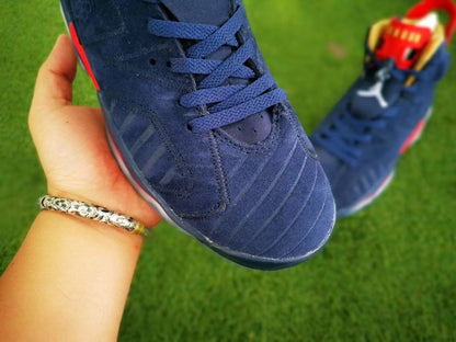 Close-up of the navy laces, perforated upper, and textured toe area.