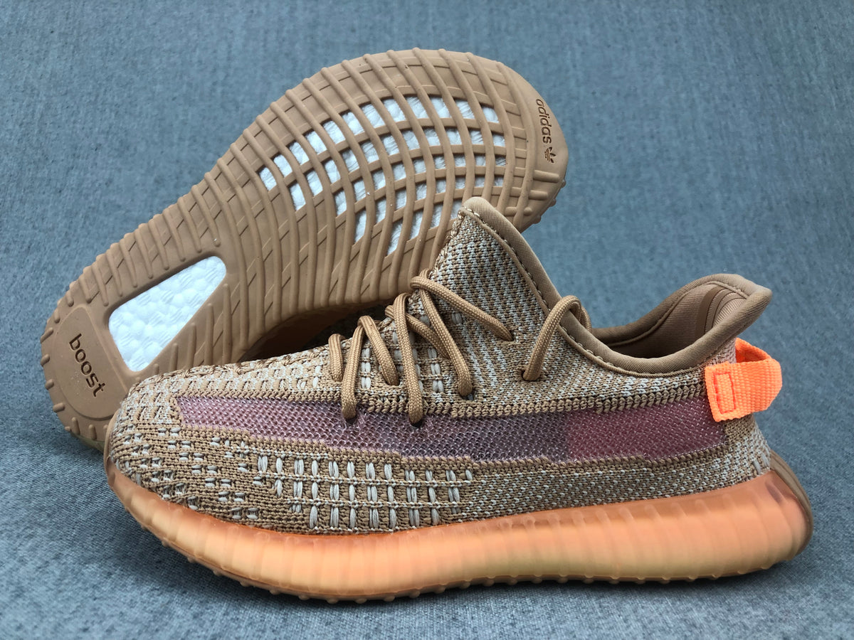 Angled view of the sneaker with the outsole lifted, showing Adidas branding and the translucent sole structure.