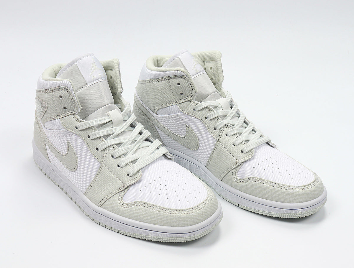 Three-quarter view of the light Spruce and white high-top sneaker pair.