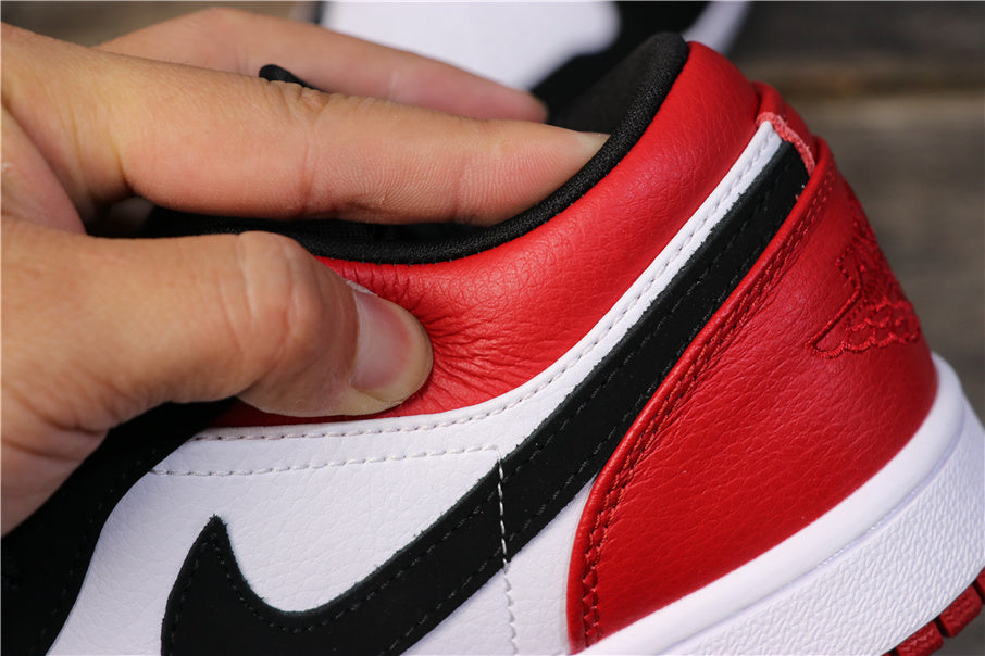 Close-up of the red heel, white trim, black Swoosh, and visible stitching.