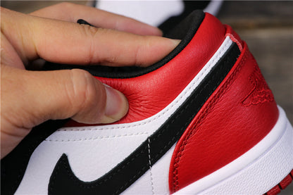 Close-up of the red heel, white trim, black Swoosh, and visible stitching.