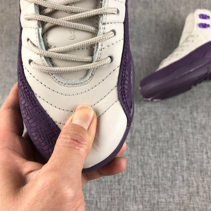 Close-up of the sneaker toe, laces, stitching, and purple side overlay