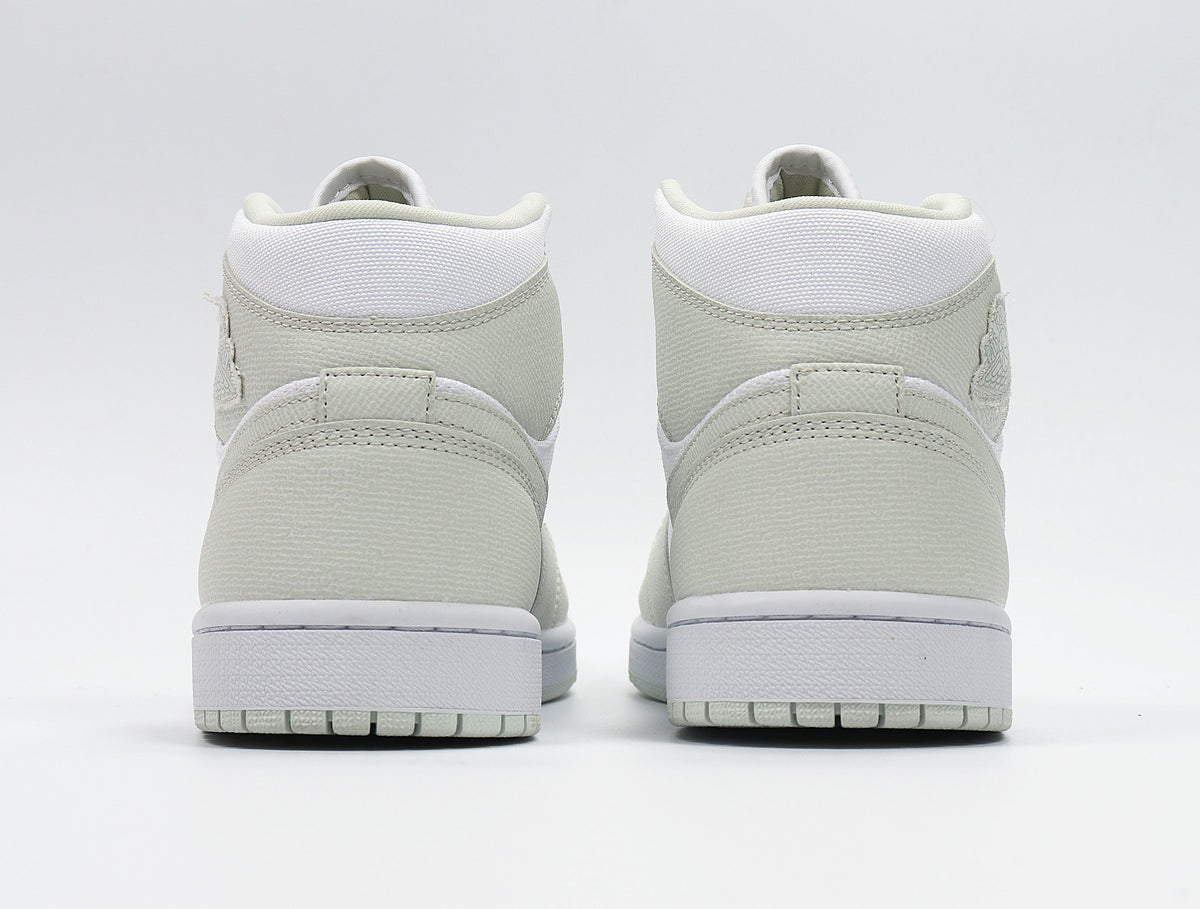 Rear view showing the padded collars, heel overlays, white midsoles, and light Spruce outsoles.