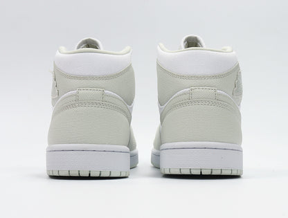 Rear view showing the padded collars, heel overlays, white midsoles, and light Spruce outsoles.