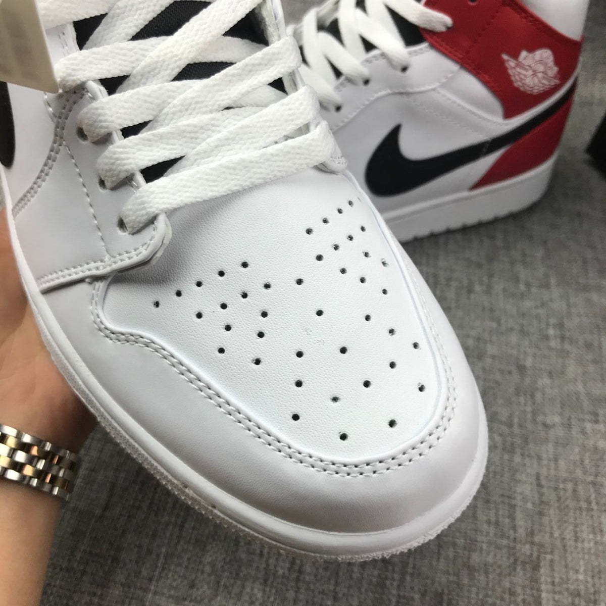 Detailed view of the perforated toe box, laces, and front stitching.