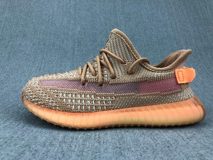 Side profile highlighting the woven upper, purple stripe, orange heel tab, and ribbed gum-colored sole.