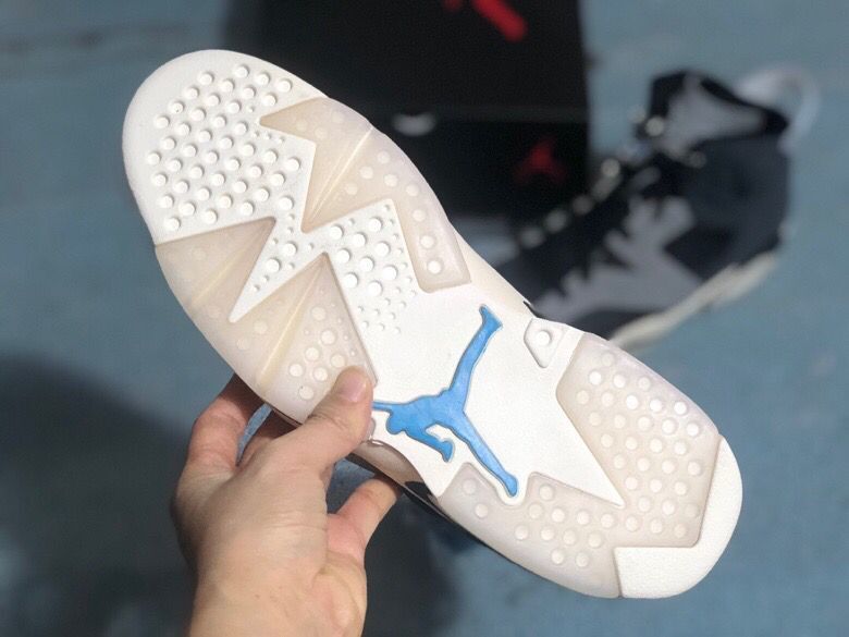 Close view of the rubber outsole showing circular traction points, geometric sections, and a blue Jumpman detail.