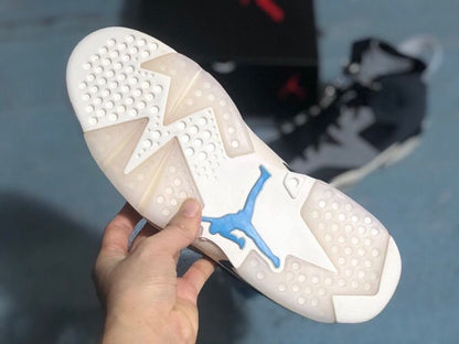 Close view of the rubber outsole showing circular traction points, geometric sections, and a blue Jumpman detail.