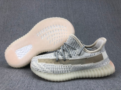 Side view with one shoe turned over to display the translucent outsole pattern.