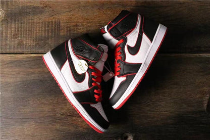 Top-down view of the pair showing the black, white, and red color blocking and a gold-colored decorative tag.