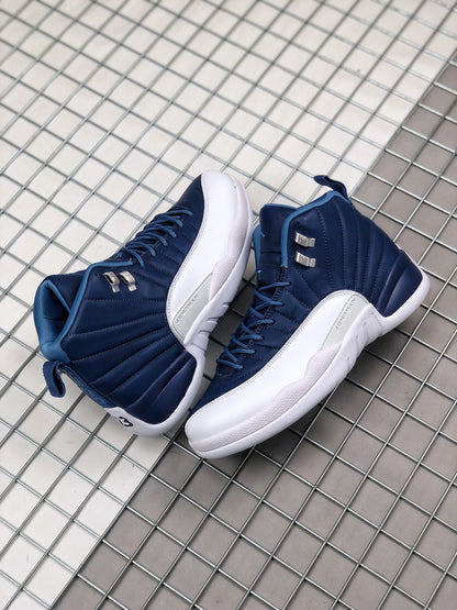 Pair of indigo and white high-top Jordan sneakers displayed on a metal grid surface.
