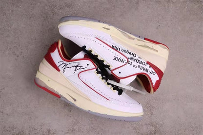 Overhead view of the pair showing layered white panels, red heel sections, and side printing.