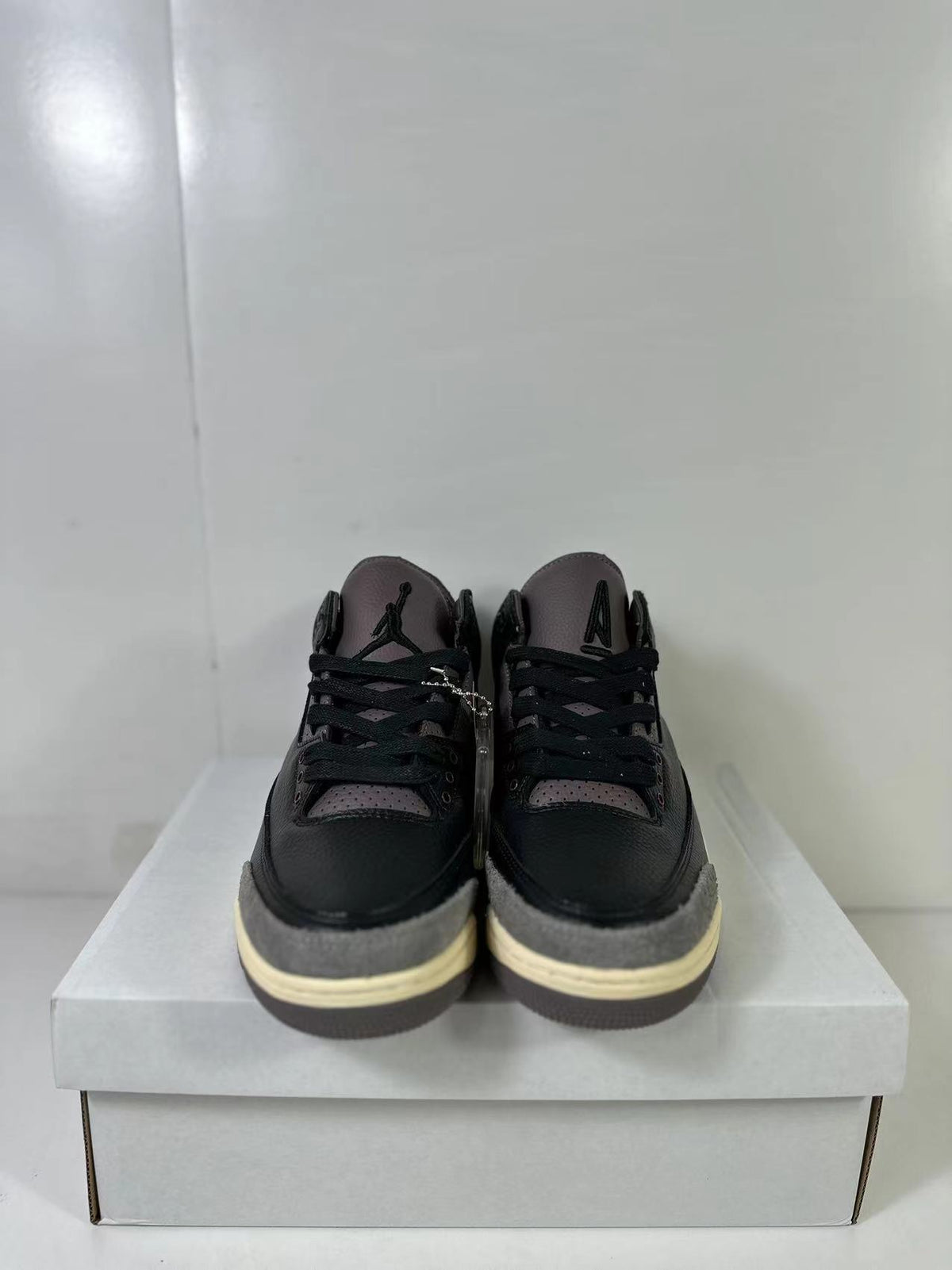 Front view of the pair showing perforated tongue and collar panels, black laces, and Jordan branding.