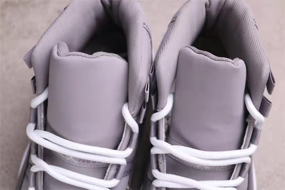 Top view showing the padded tongues, collars, and white laces of the grey high-top sneakers.