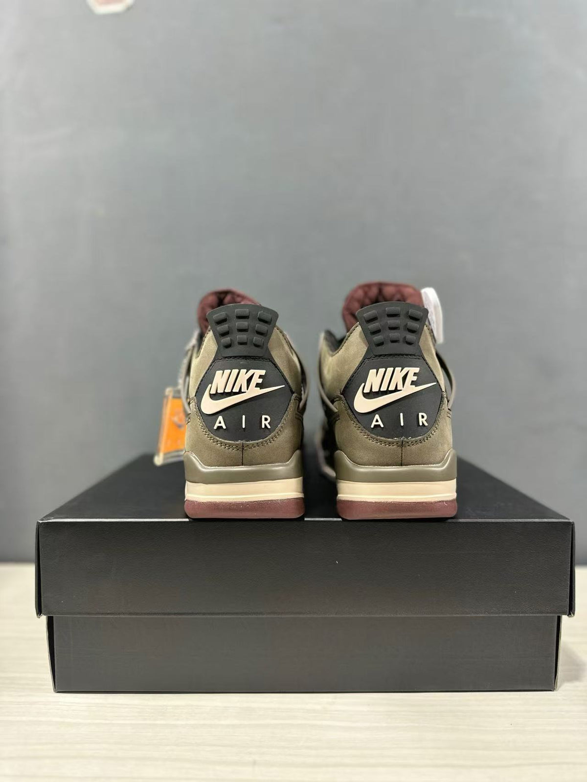 Rear view showing paired sneakers with Nike Air heel branding and mauve-toned outsoles.
