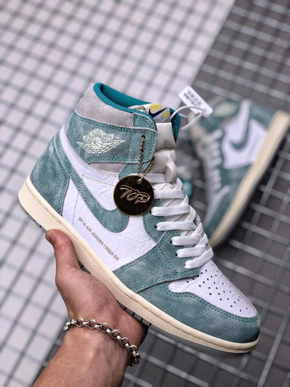 Close-up front three-quarter view showing the perforated white toe box, white laces, teal-green overlays, and hangtag.