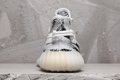 Rear view of the sneaker pair showing the padded heel area, knit upper, and rounded light-colored sole.